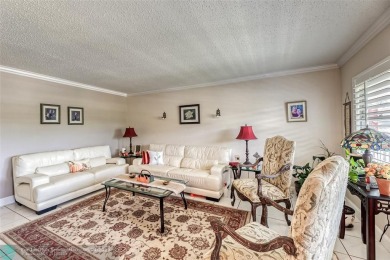 This charming, partially furnished, two bedroom, one and a half on Hillsboro Pines Golf in Florida - for sale on GolfHomes.com, golf home, golf lot