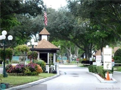 Nestled in a highly desirable International Village, this cozy on Inverrary Country Club in Florida - for sale on GolfHomes.com, golf home, golf lot