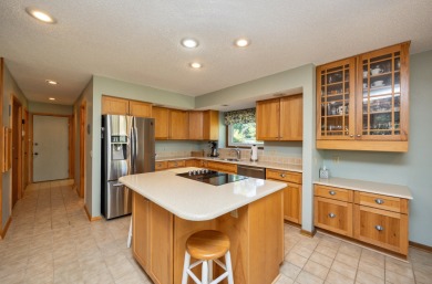 Set on a beautifully landscaped half-acre lot, this spacious on Urbandale Golf and Country Club in Iowa - for sale on GolfHomes.com, golf home, golf lot