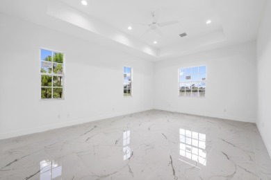 Brand-new modern estate in Palm City's prestigious Cobblestone on The Cape Club of Palm City in Florida - for sale on GolfHomes.com, golf home, golf lot