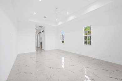 Brand-new modern estate in Palm City's prestigious Cobblestone on The Cape Club of Palm City in Florida - for sale on GolfHomes.com, golf home, golf lot