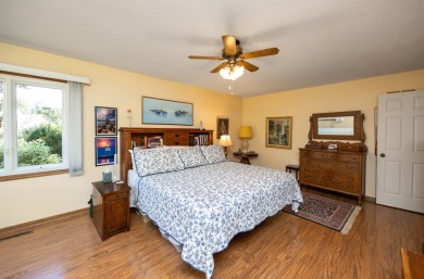 Set on a beautifully landscaped half-acre lot, this spacious on Urbandale Golf and Country Club in Iowa - for sale on GolfHomes.com, golf home, golf lot