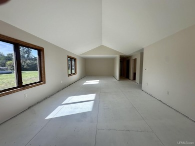 This home offers a rare opportunity to put your own finishing on Escanaba Country Club in Michigan - for sale on GolfHomes.com, golf home, golf lot