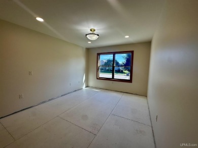 This home offers a rare opportunity to put your own finishing on Escanaba Country Club in Michigan - for sale on GolfHomes.com, golf home, golf lot