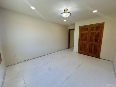 This home offers a rare opportunity to put your own finishing on Escanaba Country Club in Michigan - for sale on GolfHomes.com, golf home, golf lot