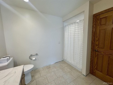 This home offers a rare opportunity to put your own finishing on Escanaba Country Club in Michigan - for sale on GolfHomes.com, golf home, golf lot