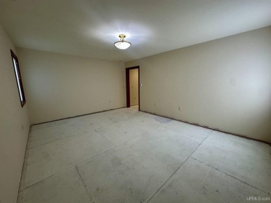 This home offers a rare opportunity to put your own finishing on Escanaba Country Club in Michigan - for sale on GolfHomes.com, golf home, golf lot