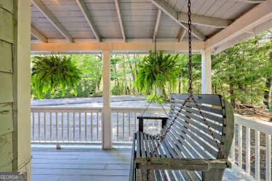 A Wrap Around Covered Porch, full of beautiful plants, welcomes on Sky Valley Resort and Country Club in Georgia - for sale on GolfHomes.com, golf home, golf lot