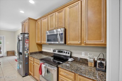 a beautifully maintained and thoughtfully upgraded 4-bedroom on Diamondhead Country Club in Mississippi - for sale on GolfHomes.com, golf home, golf lot