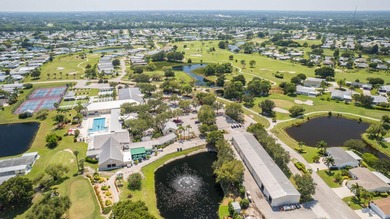 Rare corner-lot waterfront gem with wraparound water and golf on Savanna Golf Club in Florida - for sale on GolfHomes.com, golf home, golf lot