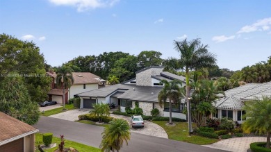 Discover a RARE GEM in Plantation's exclusive gated Coco Plum on Jacaranda Golf Club in Florida - for sale on GolfHomes.com, golf home, golf lot