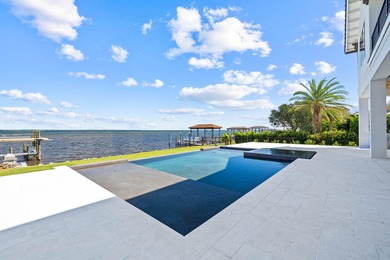480 Captains Circle is an extraordinary waterfront estate within on Regatta Bay Golf and Country Club in Florida - for sale on GolfHomes.com, golf home, golf lot