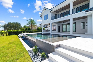 480 Captains Circle is an extraordinary waterfront estate within on Regatta Bay Golf and Country Club in Florida - for sale on GolfHomes.com, golf home, golf lot