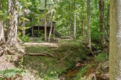 Nestled in a serene natural setting, this breathtaking 3-story on Big Canoe Golf Club - Cherokee in Georgia - for sale on GolfHomes.com, golf home, golf lot