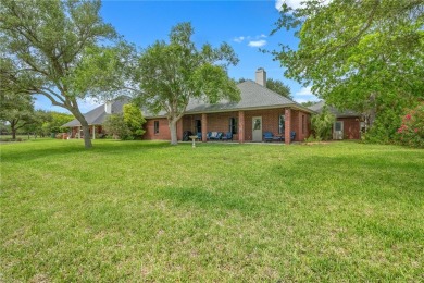 Elegant all-brick that overlooks a pond, Rockport golf course on Rockport Country Club in Texas - for sale on GolfHomes.com, golf home, golf lot