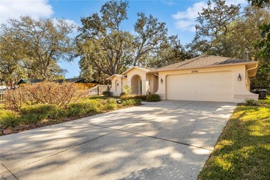 Welcome to this charming and well-maintained 2-bedroom, 2-bath on Oak Hills Country Club in Florida - for sale on GolfHomes.com, golf home, golf lot