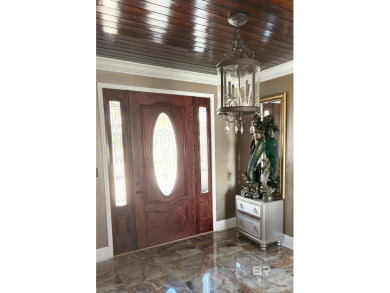 Ever dream of living on Marina Road? This single-story home on Orange Beach Golf Center in Alabama - for sale on GolfHomes.com, golf home, golf lot