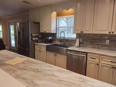 Don't miss this one! Beautifully shaded, freshly painted, well on Wildwood Country Club in Florida - for sale on GolfHomes.com, golf home, golf lot