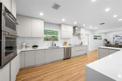 Exceptional fully renovated waterfront residence located on the on Normandy Shores Golf Course in Florida - for sale on GolfHomes.com, golf home, golf lot