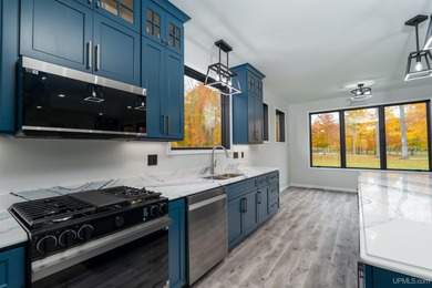 Experience refined modern living in this stunning 2025 on Indian Lake Golf and Country Club in Michigan - for sale on GolfHomes.com, golf home, golf lot