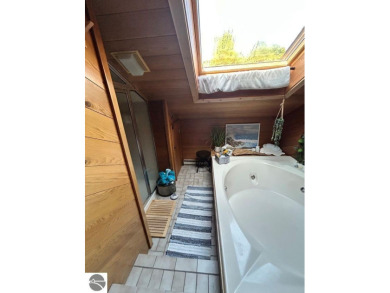 This exceptional three-bedroom, three-and-a-half bathroom condo on Shanty Creek Golf Course in Michigan - for sale on GolfHomes.com, golf home, golf lot