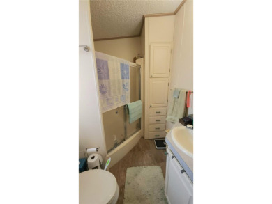 TWO BEDROOM, 1 1/2 BATHROOM MOBILE HOME IN ACTIVE 55+ COMMUNITY on River Run Golf Links in Florida - for sale on GolfHomes.com, golf home, golf lot