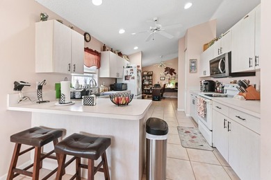 From the moment you approach, this radiant home invites you into on Cypress Lakes Golf Course - West Palm Beach in Florida - for sale on GolfHomes.com, golf home, golf lot