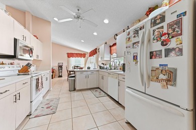 From the moment you approach, this radiant home invites you into on Cypress Lakes Golf Course - West Palm Beach in Florida - for sale on GolfHomes.com, golf home, golf lot