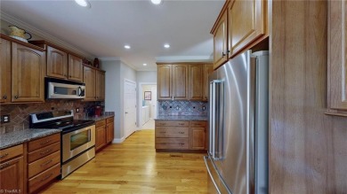 Enter the front door to view the beautiful great room w/stone on Salem Glen Country Club in North Carolina - for sale on GolfHomes.com, golf home, golf lot