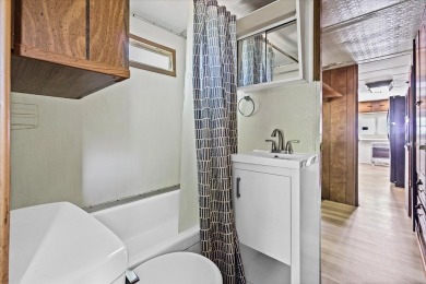 Take a look at this camper with a sunroom located in Holiday Out on Lake Tansi Village Country Club in Tennessee - for sale on GolfHomes.com, golf home, golf lot