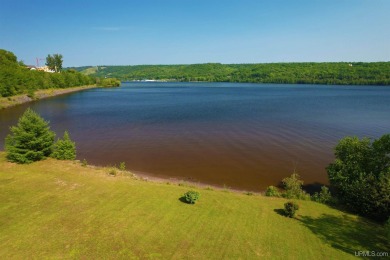 A rare opportunity to own Portage Lake waterfront property in on Portage Lake Golf Course in Michigan - for sale on GolfHomes.com, golf home, golf lot