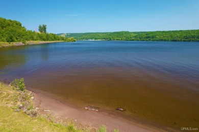 A rare opportunity to own Portage Lake waterfront property in on Portage Lake Golf Course in Michigan - for sale on GolfHomes.com, golf home, golf lot