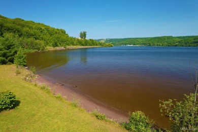 A rare opportunity to own Portage Lake waterfront property in on Portage Lake Golf Course in Michigan - for sale on GolfHomes.com, golf home, golf lot