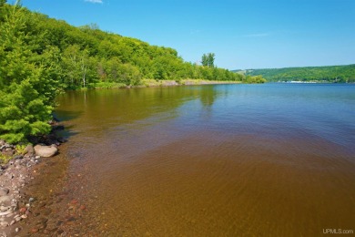 A rare opportunity to own Portage Lake waterfront property in on Portage Lake Golf Course in Michigan - for sale on GolfHomes.com, golf home, golf lot