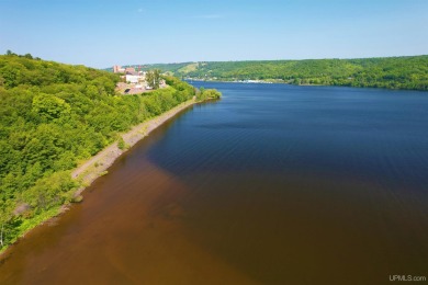 A rare opportunity to own Portage Lake waterfront property in on Portage Lake Golf Course in Michigan - for sale on GolfHomes.com, golf home, golf lot