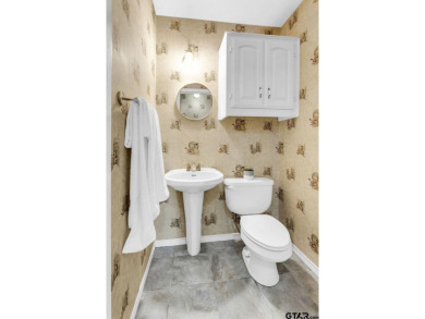 Set on a beautifully landscaped, oversized, 1 plus acre lot on Hide-A-Way Lake Golf Course in Texas - for sale on GolfHomes.com, golf home, golf lot