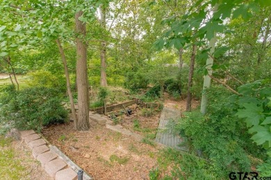 Set on a beautifully landscaped, oversized, 1 plus acre lot on Hide-A-Way Lake Golf Course in Texas - for sale on GolfHomes.com, golf home, golf lot