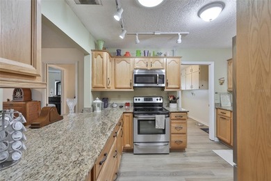 WELCOME TO THIS BEAUTIFULLY UPDATED TWINTREE residence on the on Caloosa Greens Executive Golf Course in Florida - for sale on GolfHomes.com, golf home, golf lot