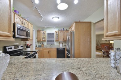 WELCOME TO THIS BEAUTIFULLY UPDATED TWINTREE residence on the on Caloosa Greens Executive Golf Course in Florida - for sale on GolfHomes.com, golf home, golf lot