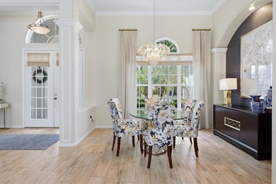 Step into a stunning, light-filled residence where elegance on University Park Country Club in Florida - for sale on GolfHomes.com, golf home, golf lot