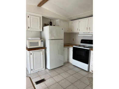 Charming 2-bedroom home in highly sought after Hidden Golf on Lake Henry Golf Club in Florida - for sale on GolfHomes.com, golf home, golf lot