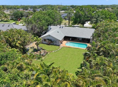 This single family pool home is nestled on a lush and tropical on The Wanderers Club in Florida - for sale on GolfHomes.com, golf home, golf lot