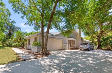 This single family pool home is nestled on a lush and tropical on The Wanderers Club in Florida - for sale on GolfHomes.com, golf home, golf lot