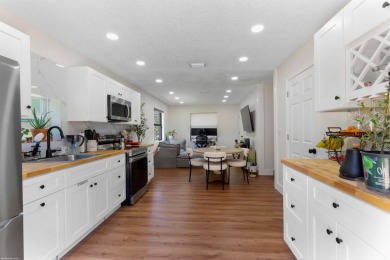 This single family pool home is nestled on a lush and tropical on The Wanderers Club in Florida - for sale on GolfHomes.com, golf home, golf lot