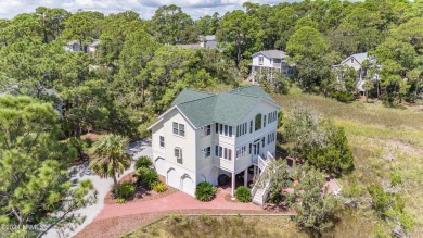 Gorgeous custom built home with enchanting marsh views. Walk to on Ocean Creek Golf Course in South Carolina - for sale on GolfHomes.com, golf home, golf lot