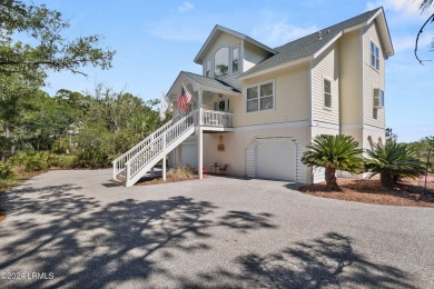 Gorgeous custom built home with enchanting marsh views. Walk to on Ocean Creek Golf Course in South Carolina - for sale on GolfHomes.com, golf home, golf lot