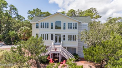 Gorgeous custom built home with enchanting marsh views. Walk to on Ocean Creek Golf Course in South Carolina - for sale on GolfHomes.com, golf home, golf lot