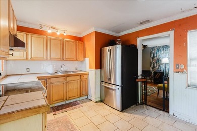 Tucked beneath the shade of mature trees in the beloved Edgemoor on Mangrove Bay Golf Course in Florida - for sale on GolfHomes.com, golf home, golf lot