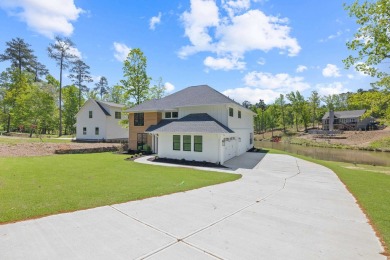 THIS GORGEOUS NEW CONSTRUCTION IS DIRECTLY ON OSPREY POINTE POND on Harbor Club Golf and Country Club in Georgia - for sale on GolfHomes.com, golf home, golf lot