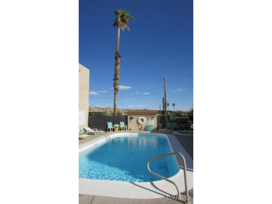 Easy access downstairs condo with patio view of pool and spa on Chaparral Golf and Country Club in Arizona - for sale on GolfHomes.com, golf home, golf lot